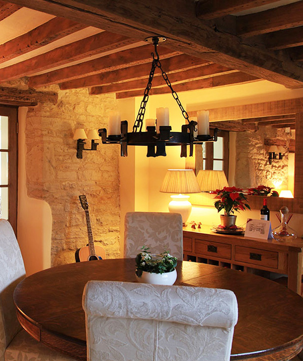 A candle lit Midhope chandelier for a cottage