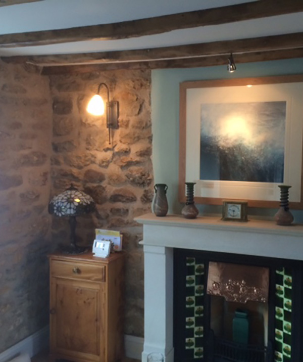 A stone cottage with our wrought iron lighting