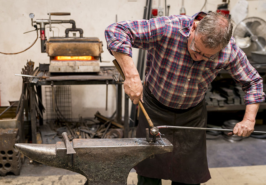 Nigel Tyas working at the anvil