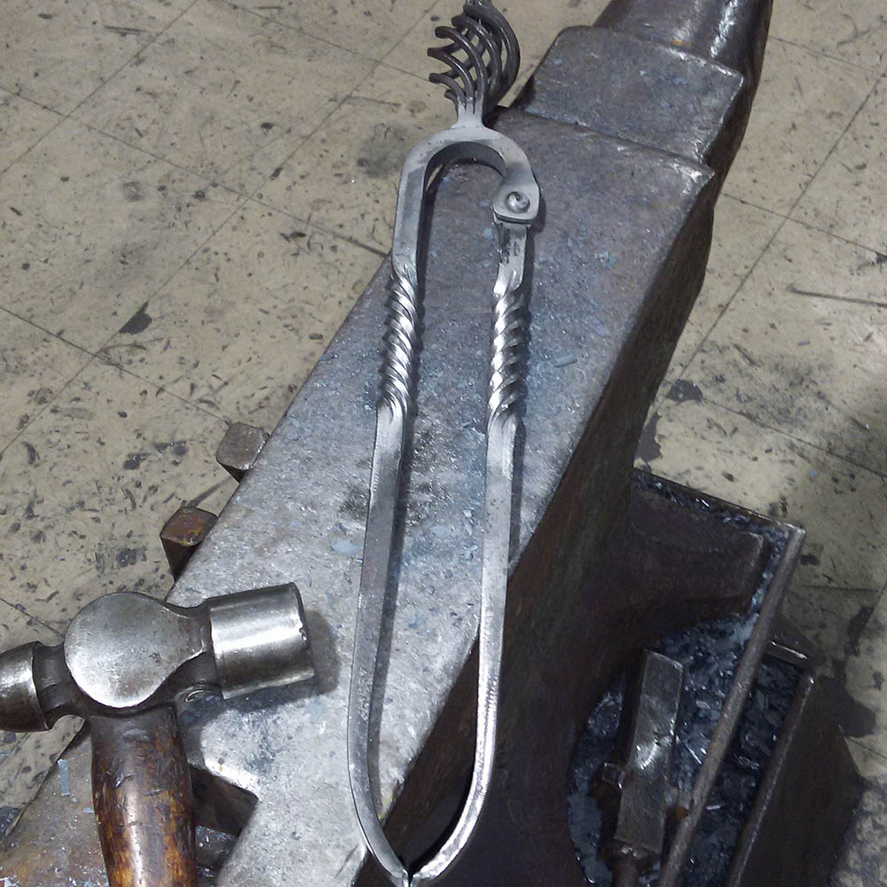 Fireside irons on the anvil